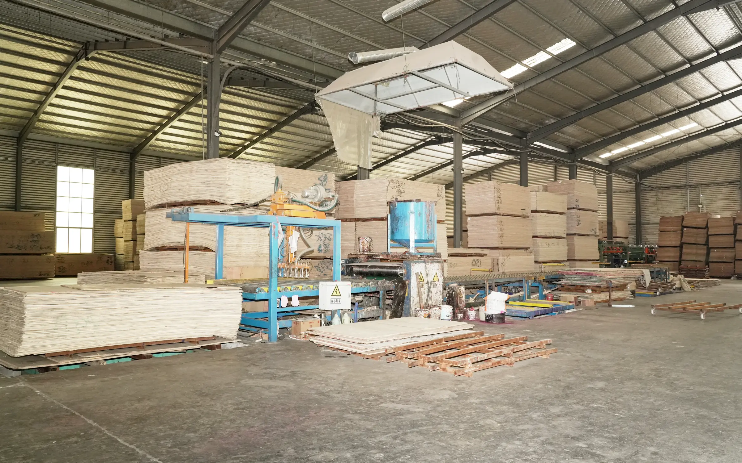 Glue application and plywood lay-up line inside the factory